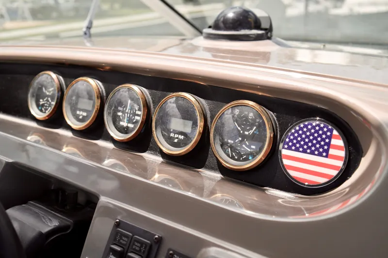 Slide: The Image of Dashboard of 1999 Carver 450 Voyager Pilothouse with gauges and American flag emblem. - 73