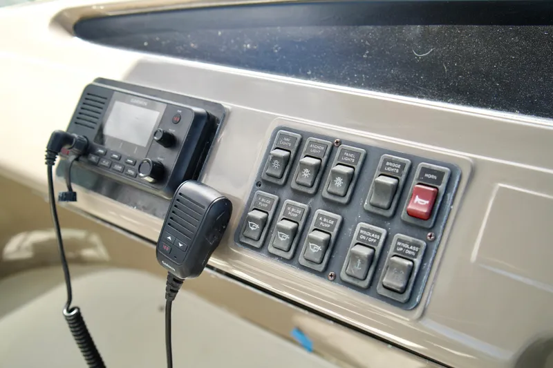 Slide: The Image of Control panel of a 1999 Carver 450 Voyager Pilothouse with radio and switches. - 76