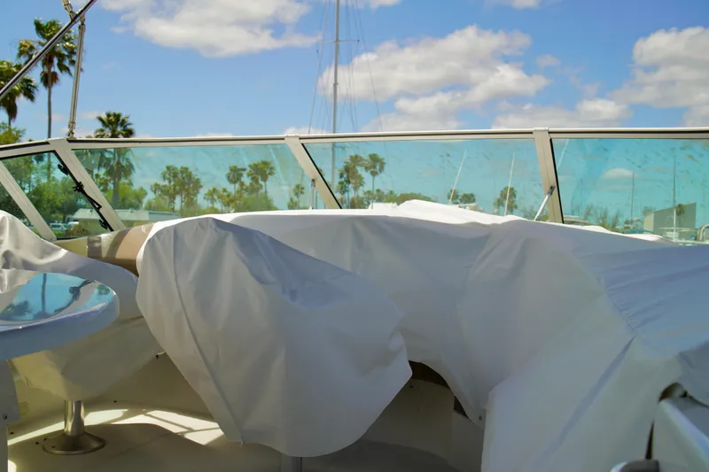 Slide: The Image of Covered seating area on a 1999 Carver 450 Voyager Pilothouse yacht under a sunny sky. - 80