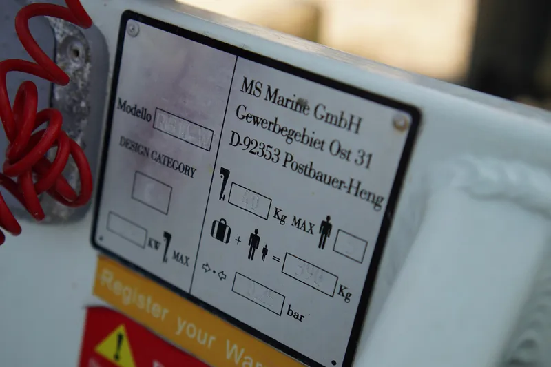 Slide: The Image of Close-up of a Carver 450 Voyager Pilothouse 1999 label with specifications and safety information. - 88