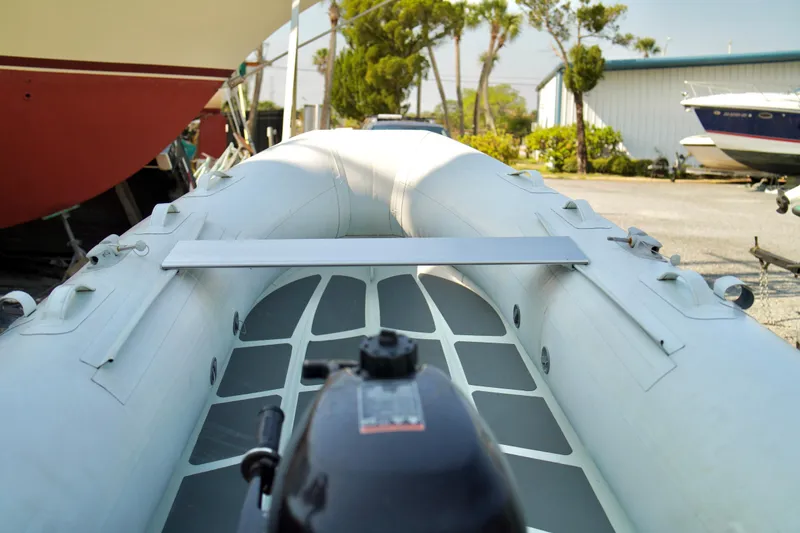 Slide: The Image of Inflatable boat with motor, docked near Carver 450 Voyager Pilothouse, 1999 model. - 90