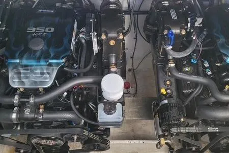 Slide: The Image of Twin engines of a 2004 Maxum 3100 SE boat, showcasing detailed mechanical components. - 11