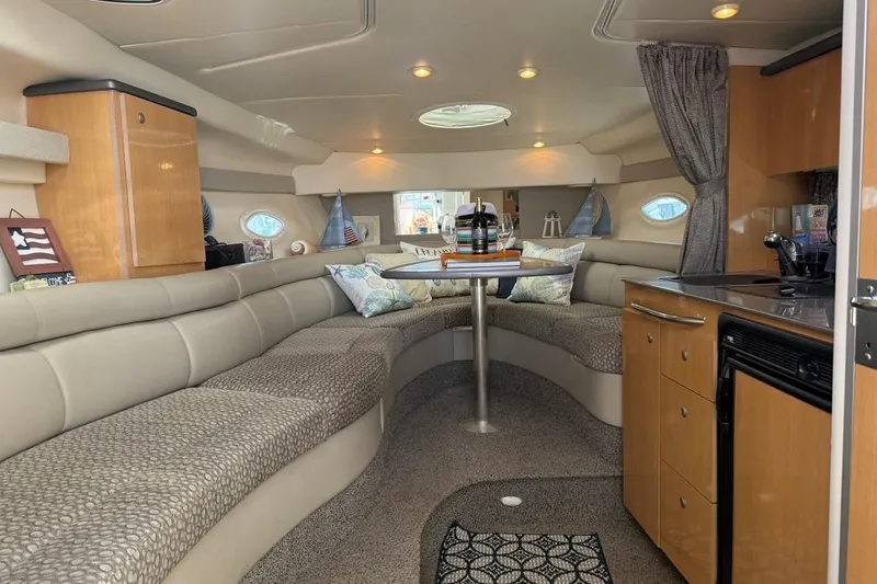 Slide: The Image of Luxurious interior of a 2004 Maxum 3100 SE boat with cozy seating and kitchenette. - 5