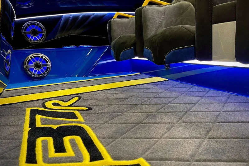 Slide: The Image of Interior of 2022 DCB M37 boat with custom seating and vibrant blue lighting. - 10