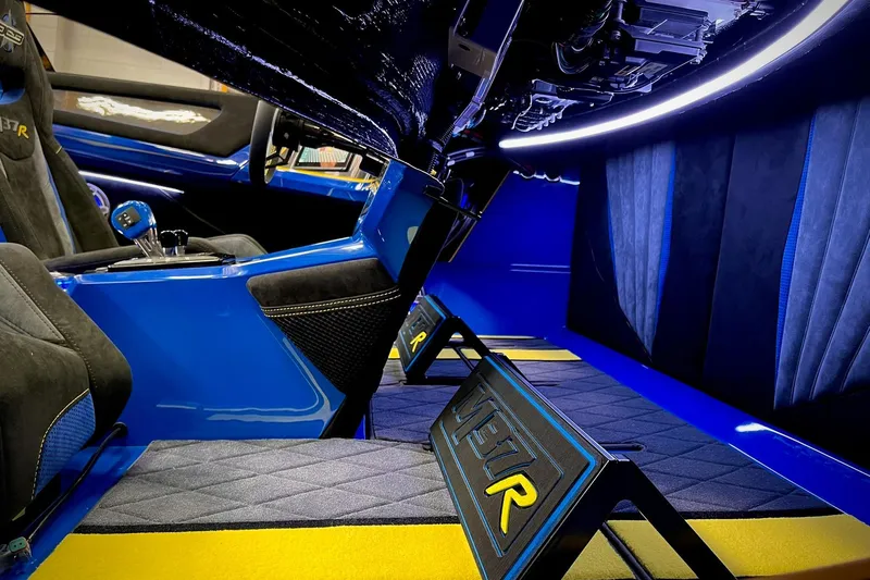 Slide: The Image of Interior of a 2022 DCB M37 boat, featuring sleek blue and black design elements. - 20