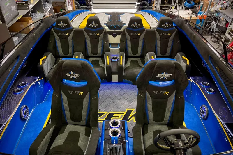 Slide: The Image of Luxurious interior of 2022 DCB M37 boat with blue and black seating. - 21