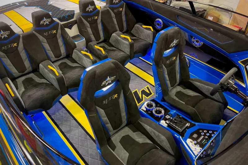 Slide: The Image of Luxurious interior of 2022 DCB M37 boat with custom seating and vibrant blue accents. - 22