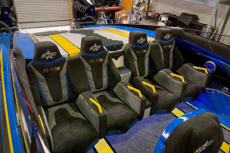 Slide: The Image of Interior of 2022 DCB M37 boat with luxurious seating and vibrant blue accents. - 23