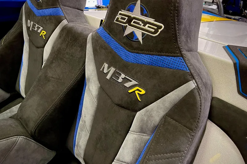 Slide: The Image of 2022 DCB M37 boat seats with blue accents and embroidered logos. - 26