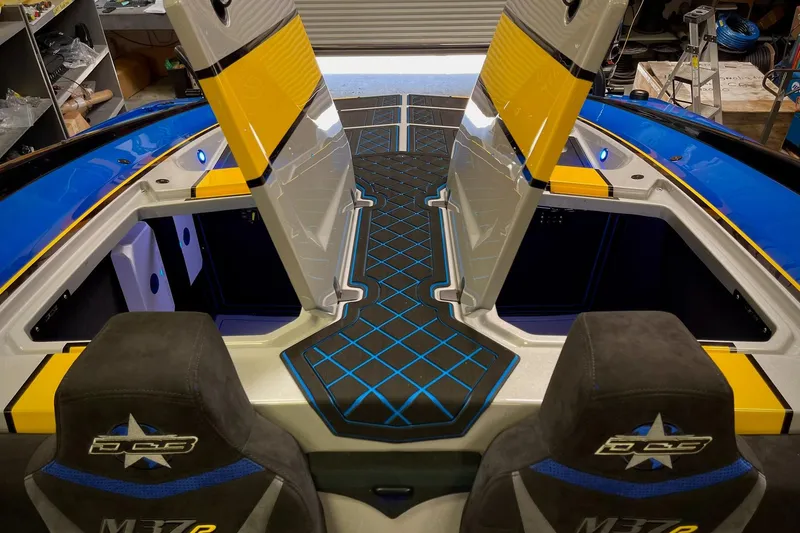 Slide: The Image of Interior of a 2022 DCB M37 boat with vibrant blue and yellow accents. - 27