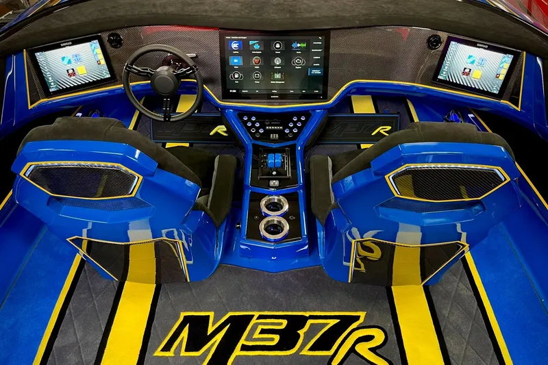 Slide: The Image of Interior of 2022 DCB M37 boat with advanced dashboard and blue seating. - 5