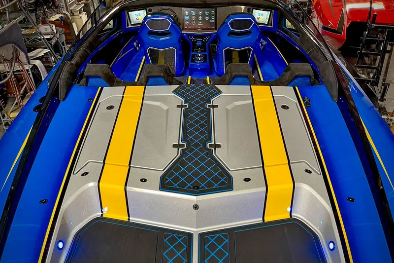 Slide: The Image of 2022 DCB M37 boat interior with vibrant blue and yellow design, featuring advanced dashboard controls. - 6