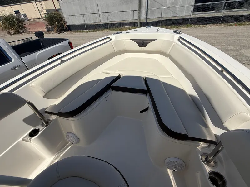 Slide: The Image of 2023 Sailfish 220 CC boat interior with cushioned seating and cup holders. - 11