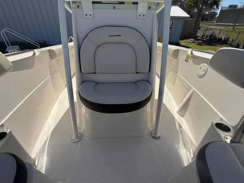 Slide: The Image of 2023 Sailfish 220 CC boat interior with cushioned seating and sleek design. - 12