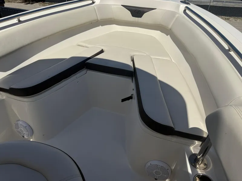 Slide: The Image of 2023 Sailfish 220 CC boat interior with cushioned seating and speakers. - 15