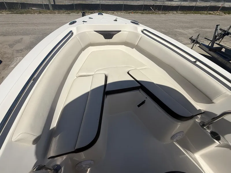 Slide: The Image of 2023 Sailfish 220 CC boat interior with cushioned seating and sleek design. - 18