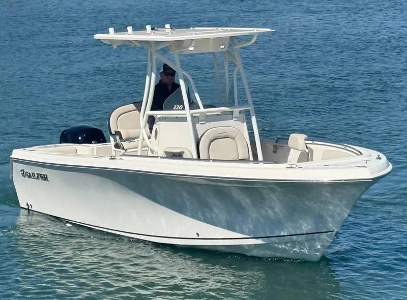 Slide: The Image of 2023 Sailfish 220 CC boat on water, featuring sleek design and modern amenities. - 2