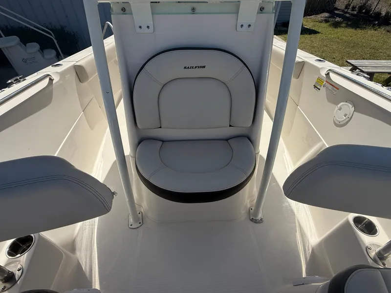 Slide: The Image of 2023 Sailfish 220 CC boat interior with white seating and cup holders. - 24