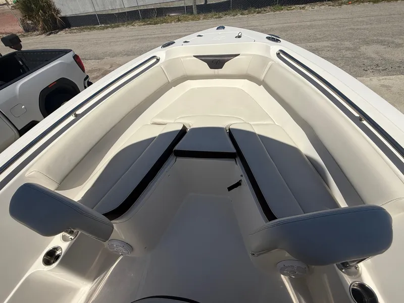 Slide: The Image of 2023 Sailfish 220 CC boat interior with cushioned seating and sleek design. - 25