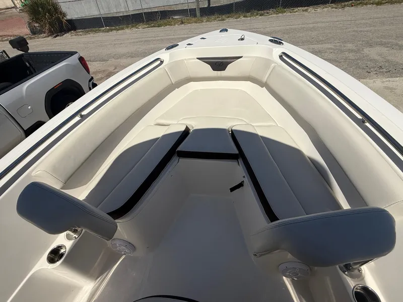 Slide: The Image of 2023 Sailfish 220 CC boat interior with cushioned seating and sleek design. - 26
