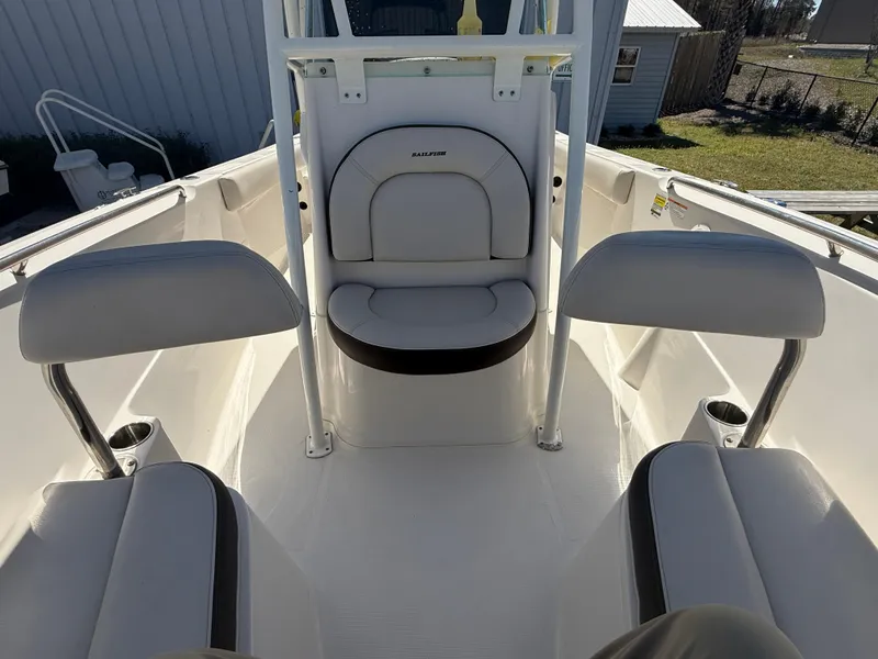 Slide: The Image of 2023 Sailfish 220 CC boat interior with cushioned seating and cup holders. - 30