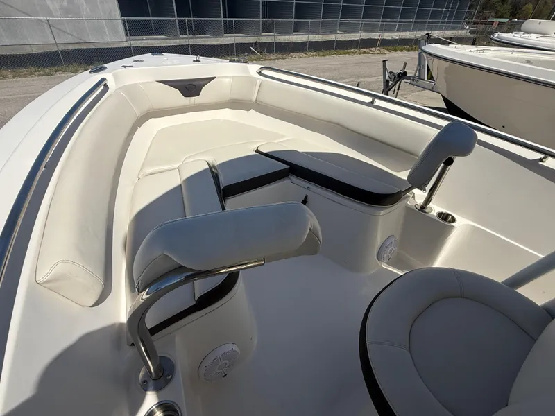 Slide: The Image of 2023 Sailfish 220 CC boat interior with cushioned seating and modern design. - 31
