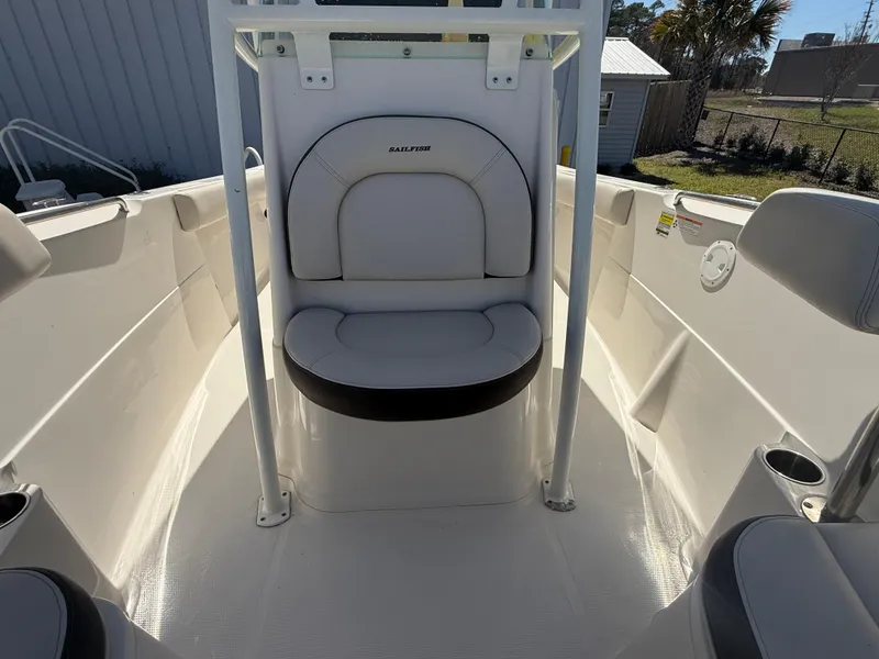 Slide: The Image of 2023 Sailfish 220 CC boat interior with cushioned seating and storage. - 32