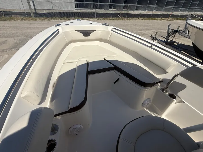Slide: The Image of 2023 Sailfish 220 CC boat interior with cushioned seating and cup holders. - 33