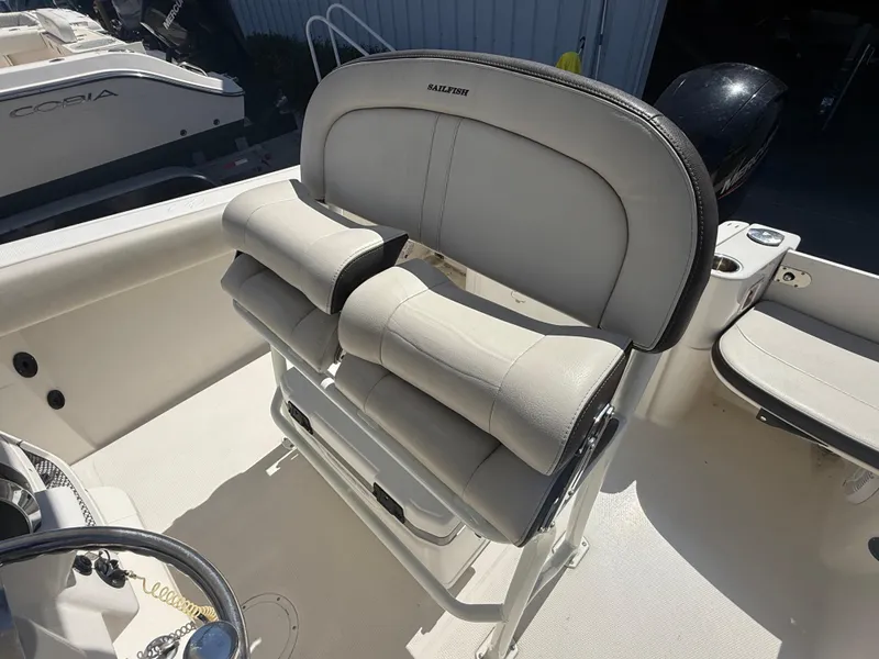 Slide: The Image of 2023 Sailfish 220 CC boat with cushioned seating and sleek design. - 34