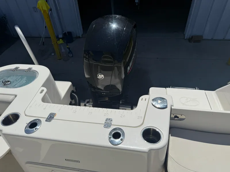 Slide: The Image of 2023 Sailfish 220 CC boat with outboard motor and fishing rod holders. - 43