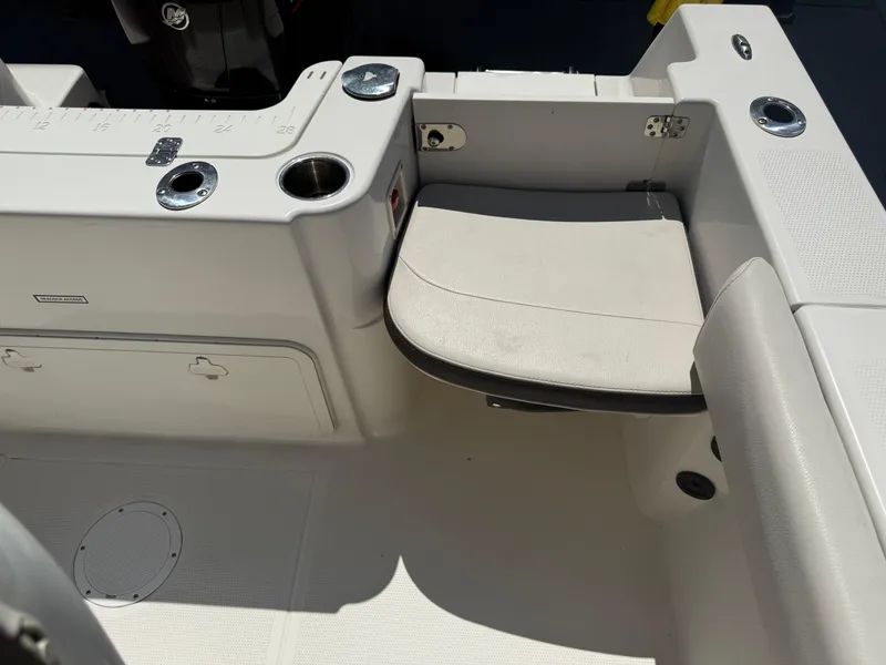 Slide: The Image of 2023 Sailfish 220 CC boat interior with foldable seat and cup holders. - 44