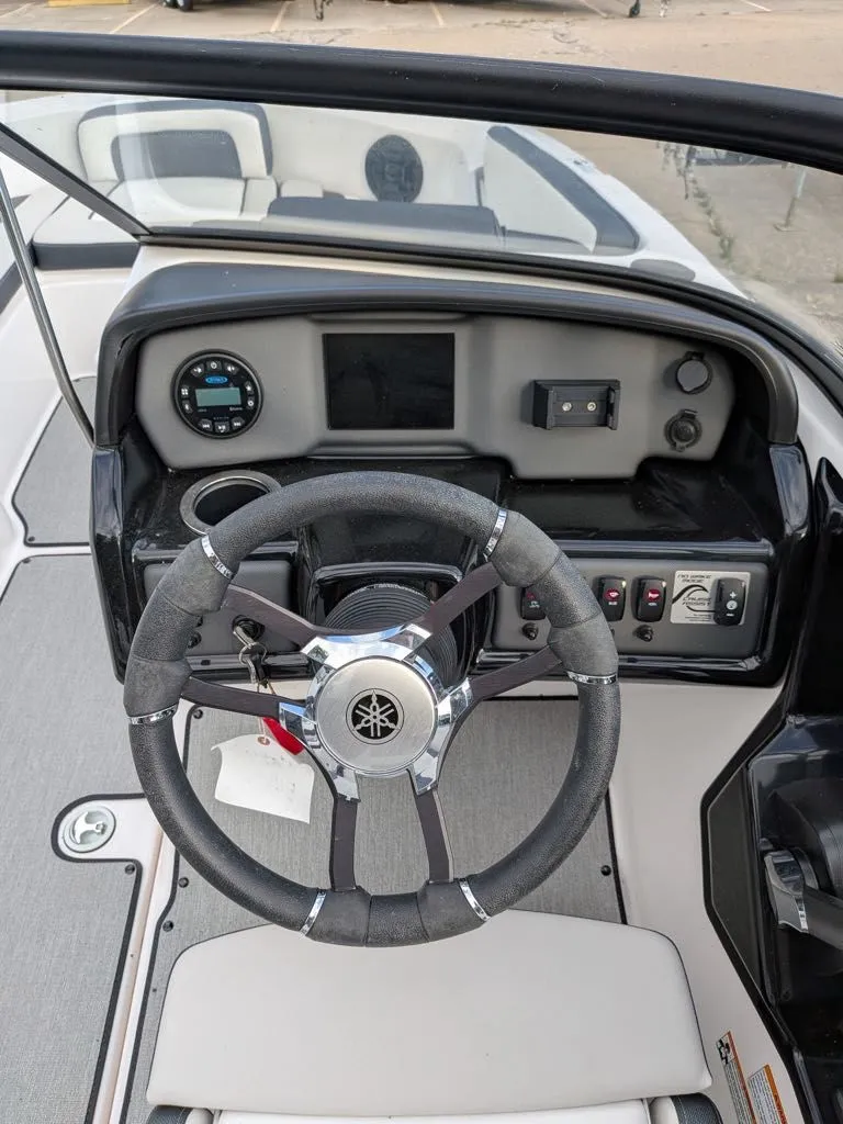 Slide: The Image of Yamaha SX195 2023 boat dashboard with steering wheel and controls. - 13
