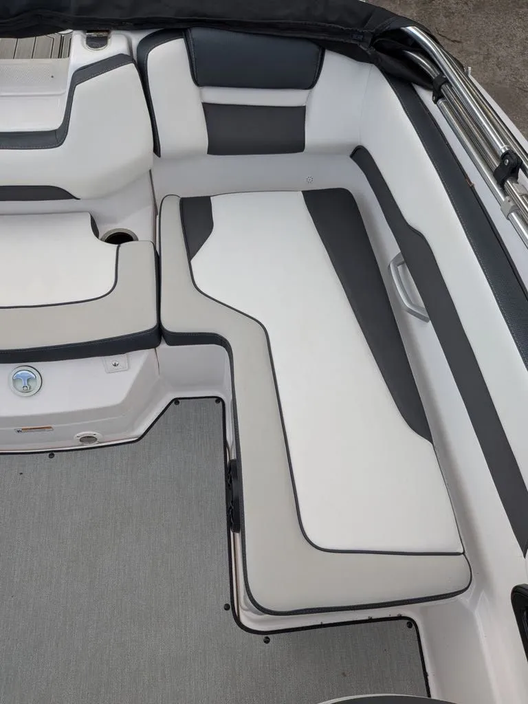 Slide: The Image of Interior of a 2023 Yamaha SX195 boat with gray and white seating. - 16