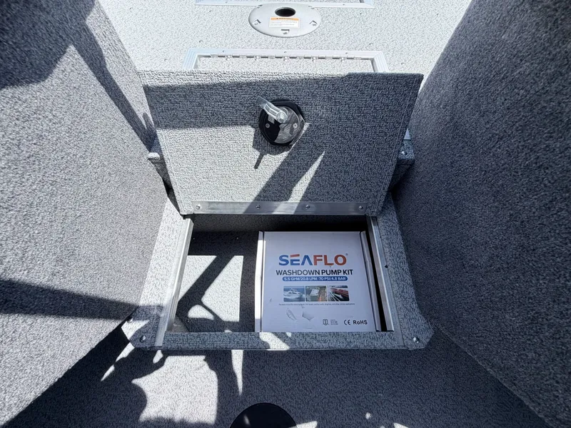 Slide: The Image of Starcraft Fishmaster 196 2026 with SEAFLO pump kit in storage compartment. - 48