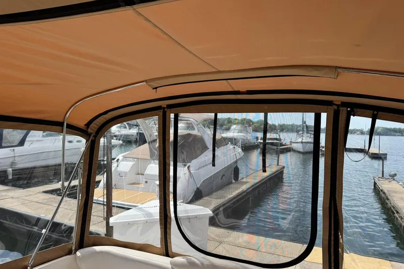 Slide: The Image of Interior view of a 2001 Sea Ray 340 Sundancer docked at a marina. - 10