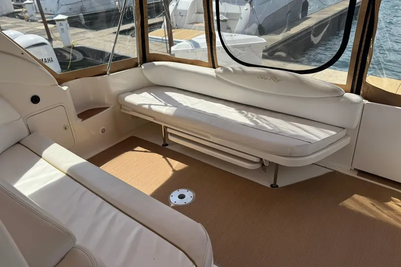 Slide: The Image of Interior of a 2001 Sea Ray 340 Sundancer yacht with white seating and marina view. - 11