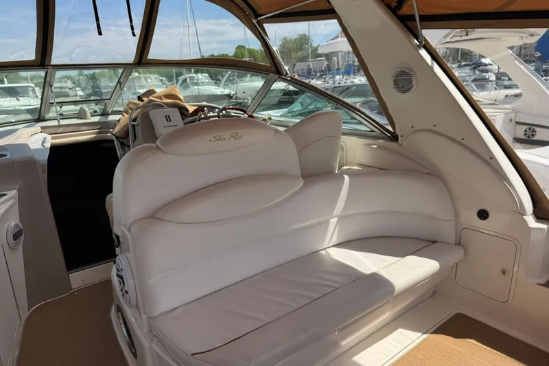 Slide: The Image of Interior of 2001 Sea Ray 340 Sundancer yacht with white seating and helm. - 12