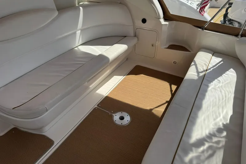 Slide: The Image of Interior seating area of a 2001 Sea Ray 340 Sundancer yacht with white upholstery. - 15
