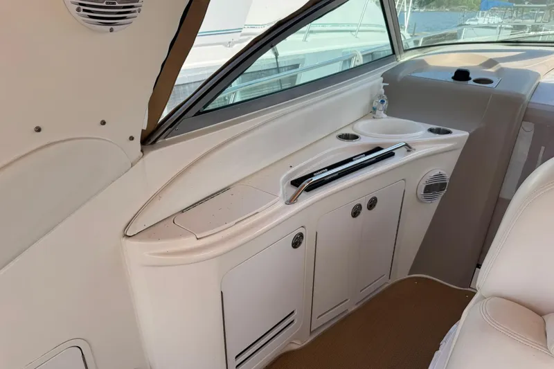 Slide: The Image of 2001 Sea Ray 340 Sundancer interior with storage cabinets and cup holders. - 20