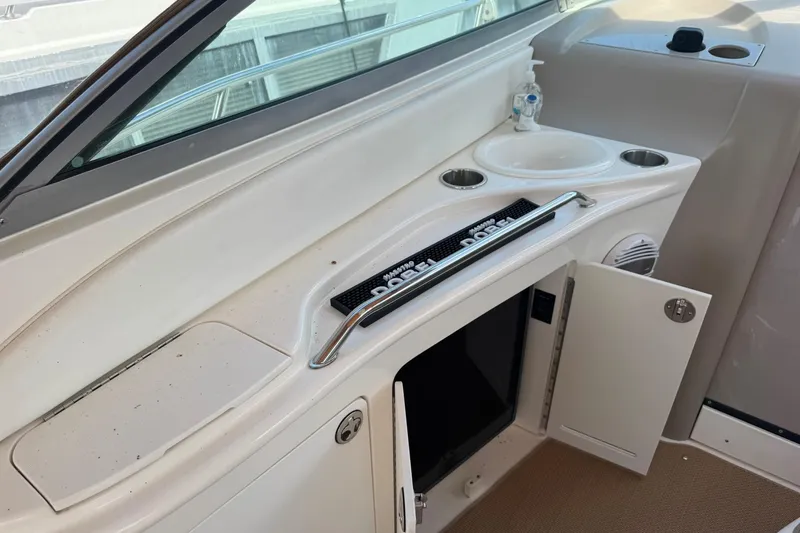 Slide: The Image of 2001 Sea Ray 340 Sundancer boat interior with sink, storage, and cup holders. - 21