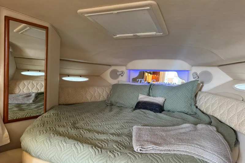 Slide: The Image of Cozy cabin interior of 2001 Sea Ray 340 Sundancer with bed and mirror. - 24