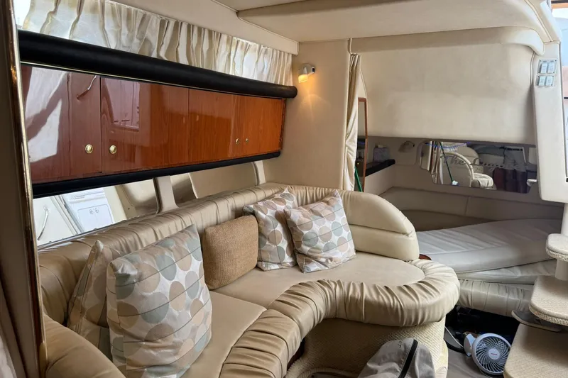 Slide: The Image of Interior of 2001 Sea Ray 340 Sundancer yacht with plush seating and elegant wood cabinetry. - 28