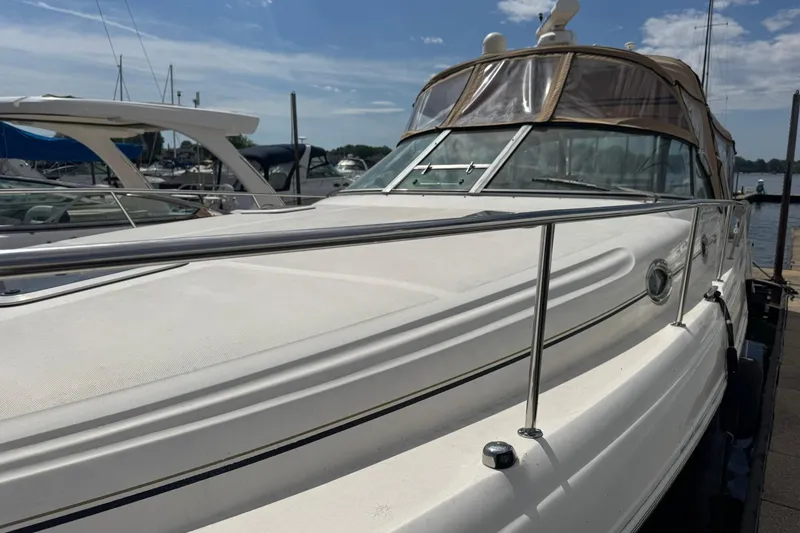 Slide: The Image of 2001 Sea Ray 340 Sundancer docked at marina under clear blue sky. - 3