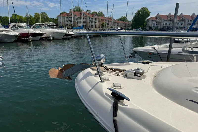 Slide: The Image of 2001 Sea Ray 340 Sundancer docked in a marina with other boats and waterfront buildings. - 4
