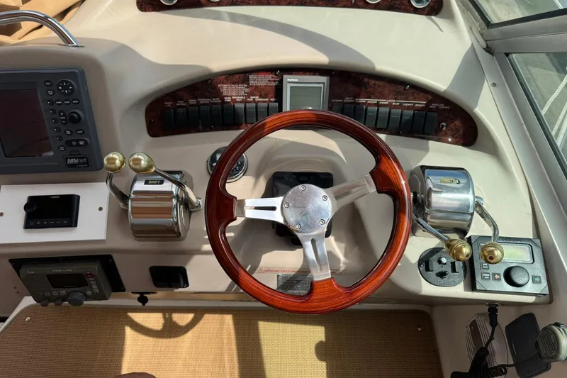 Slide: The Image of 2001 Sea Ray 340 Sundancer helm with wooden steering wheel and control panel. - 5