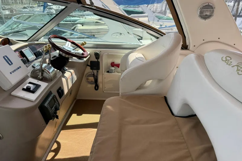 Slide: The Image of Cockpit of 2001 Sea Ray 340 Sundancer with steering wheel and navigation equipment. - 7