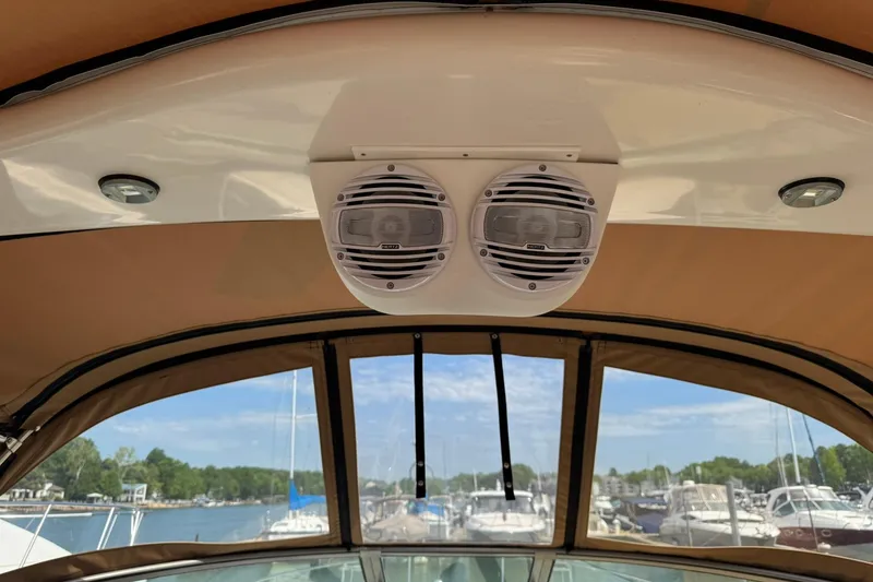 Slide: The Image of 2001 Sea Ray 340 Sundancer boat speakers and canopy with marina view. - 8