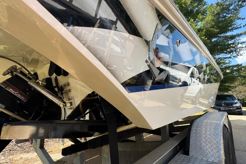 Slide: The Image of 2004 Fountain 27 Fever boat on trailer, reflecting surroundings, with visible MerCruiser engine components. - 11