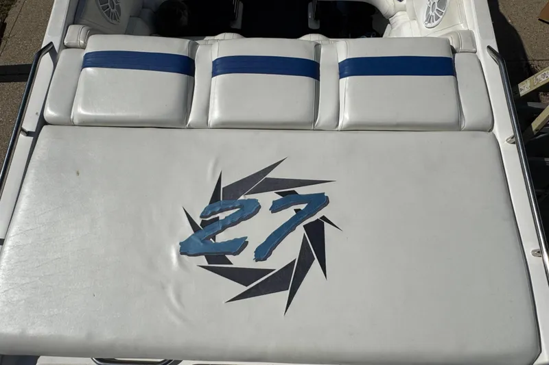 Slide: The Image of 2004 Fountain 27 Fever boat with white seating and blue accents. - 14