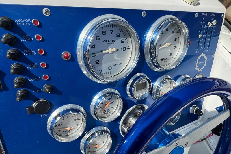 Slide: The Image of Dashboard of a 2004 Fountain 27 Fever boat with gauges and controls. - 18